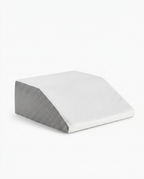 White and grey memory foam leg elevation wedge pillow on a white background