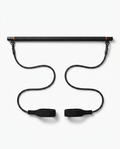 Black Pilates bar kit with resistance bands and foot straps on white