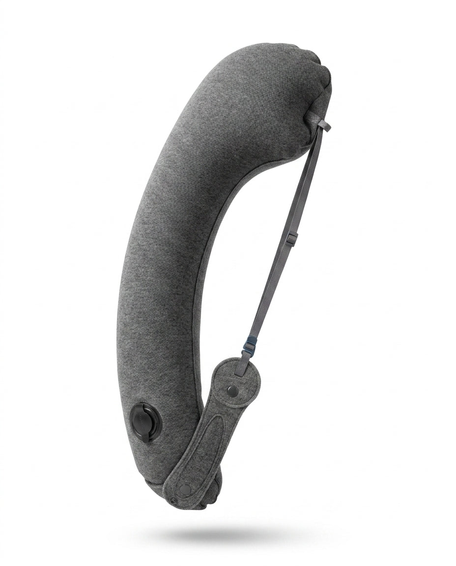 Grey inflatable travel neck pillow with valve and strap, studio shot on white