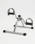Silver under-desk mini pedal exercise bike with foot straps, studio shot on white