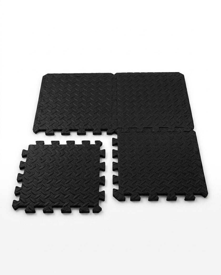 Black EVA foam puzzle exercise mat tiles with interlocking edges on white