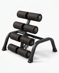 Black steel back stretch and core training bench with padded rollers, studio shot on white