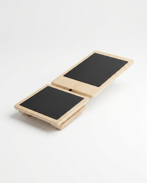 Wooden ankle balance board with two pivoting non-slip platforms on white