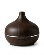 Dark wood-grain essential oil aromatherapy diffuser with timer buttons, studio shot