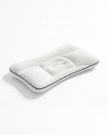 White baby head support pillow with concave cradle and navy piping, studio shot