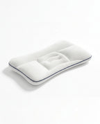 White baby head support pillow with concave cradle and navy piping, studio shot