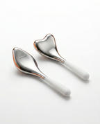 Heart and teardrop stainless steel cooling eye massage tools with white silicone handles