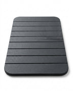 Dark grey grooved diatomite stone bath mat on a white background