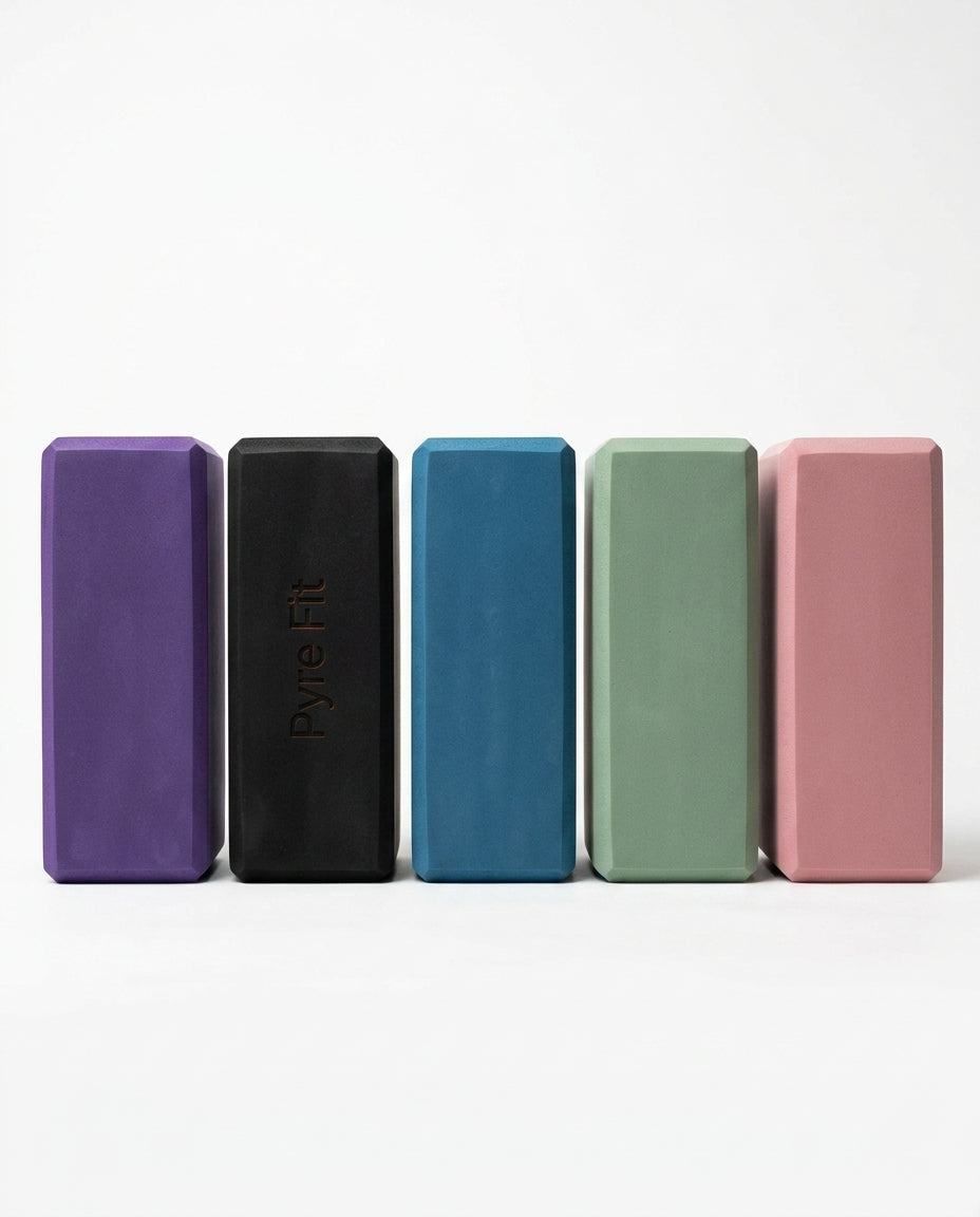 Lineup of EVA foam yoga blocks in purple, black, blue, green, and pink