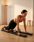 Woman doing an ab rollout on the foldable pilates board at home