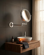 Wall-mounted vanity mirror above a wood vanity in a dark modern bathroom