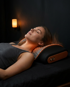 Woman resting in bed with the heated neck pillow glowing warm in dim lighting