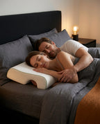 Couple sleeping close, the woman cradled on the couples pillow with arm cutout