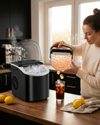 Woman pouring ice from the countertop maker into a glass in a sunny kitchen