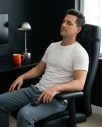 Man relaxing in an office chair fitted with the massage cushion