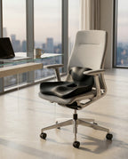 Black memory foam seat cushion resting on a white office chair by a window