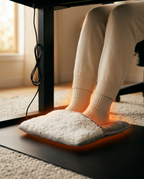 Feet warming inside the foot heating pad under an office desk