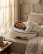 Woman side-sleeping in bed with her shoulder nestled in the pillow cutout