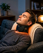Man relaxing on a couch in the evening wearing the warm neck wrap