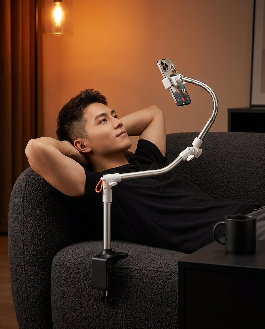 Man on a couch viewing a phone held by the clamp-mounted flexible stand