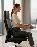 Woman working at a desk seated on the memory foam cushion in an office chair