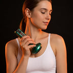 Woman using the green cupping massager on her neck and collarbone