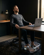 Man relaxing at his desk with feet soaking in the foot spa basin