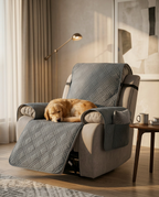 Golden retriever resting on a recliner protected by the grey quilted cover