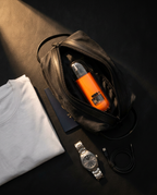 Orange nose and ear trimmer packed in a black travel dopp kit with cable