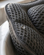 Macro of the 3D air-mesh texture with a water droplet on the bath pillow