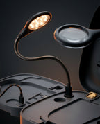 Macro of the foot station's gooseneck LED lamp and magnifying mirror
