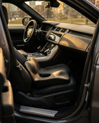 Black memory foam seat cushion placed on the driver's seat of an SUV
