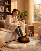 Woman relaxing on sofa with feet in heated foot warmer at evening