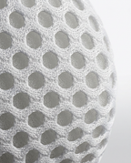 Macro of the white 3D honeycomb air-mesh fabric on the neck traction pillow