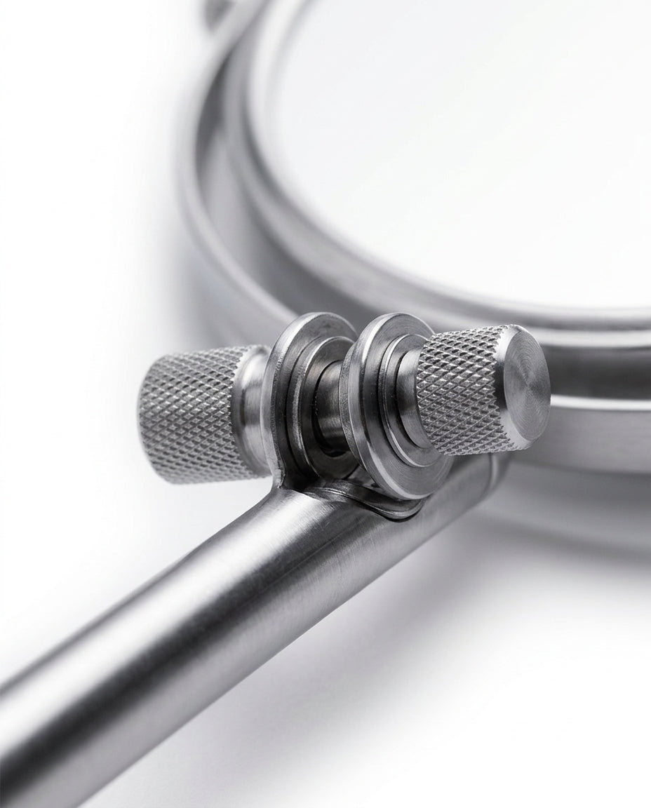 Macro of the knurled chrome swivel joints connecting the mirror to its arm