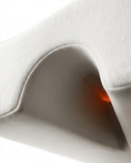 Macro of the arch-shaped arm tunnel passing through the cream couples pillow
