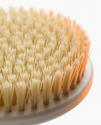Macro close-up of the soft cream bristles of the body brush head