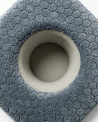 Top-down macro of the soft center ear-relief cavity on the piercing pillow