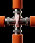 Macro of the chrome center hub joining the posture stick's four foam arms
