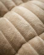Macro of the soft channel-quilted velvet on the beige reading wedge pillow