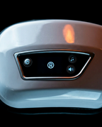 Macro of the eye massager's touch control panel with mode and music buttons