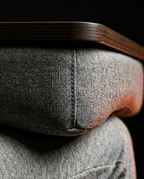 Macro of the plush grey cushion base under the wooden lap desk edge