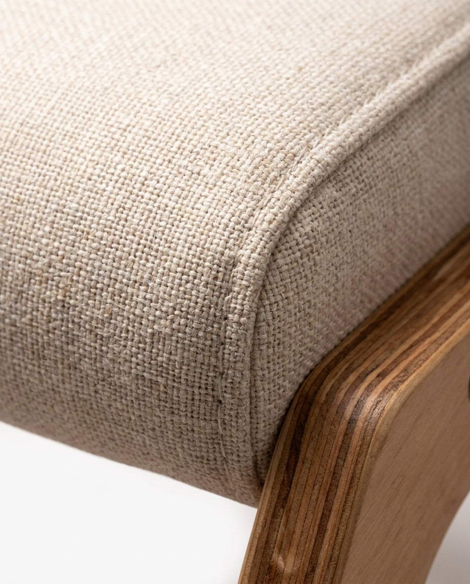 Macro of the linen cushion seam meeting the bentwood frame