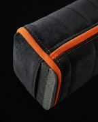 Macro of black velvet fabric with orange piping and contrast stitching on the wedge