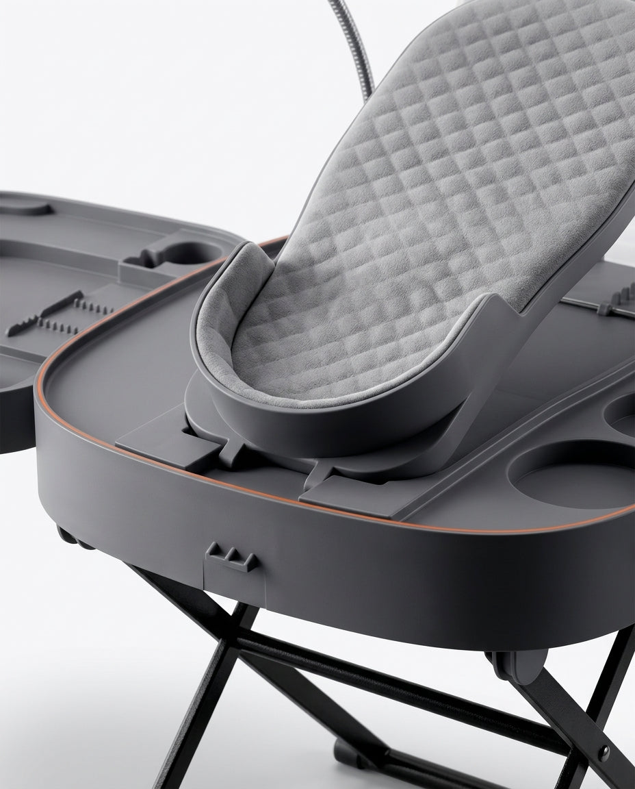 Close-up of the cushioned grey foot cradle pad on the foot care station