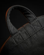 Macro top-down of the reinforced stitched carry handle on the fabric pillow