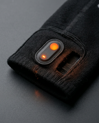 Macro of the heated sock's power button and glowing toe heating element