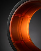 Macro of the reinforced orange inner core and matte black rim of the roller