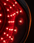 Macro of the glowing red LEDs lining the interior of the hair growth cap