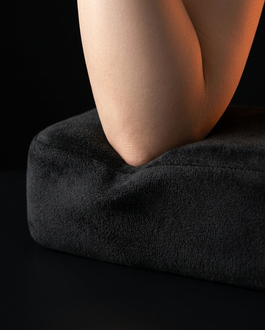 Macro of an elbow sinking into the plush black memory foam armrest